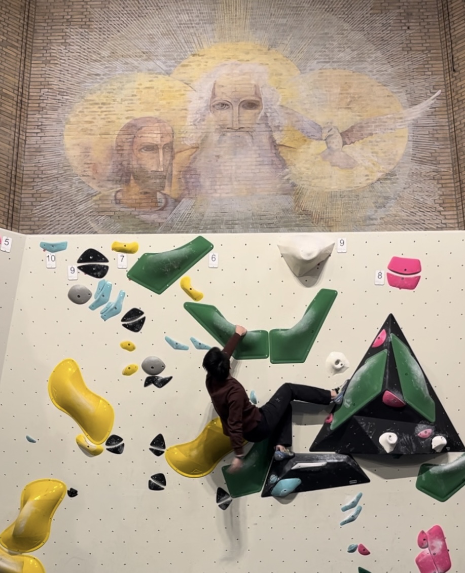 Bouldering under a religious mural