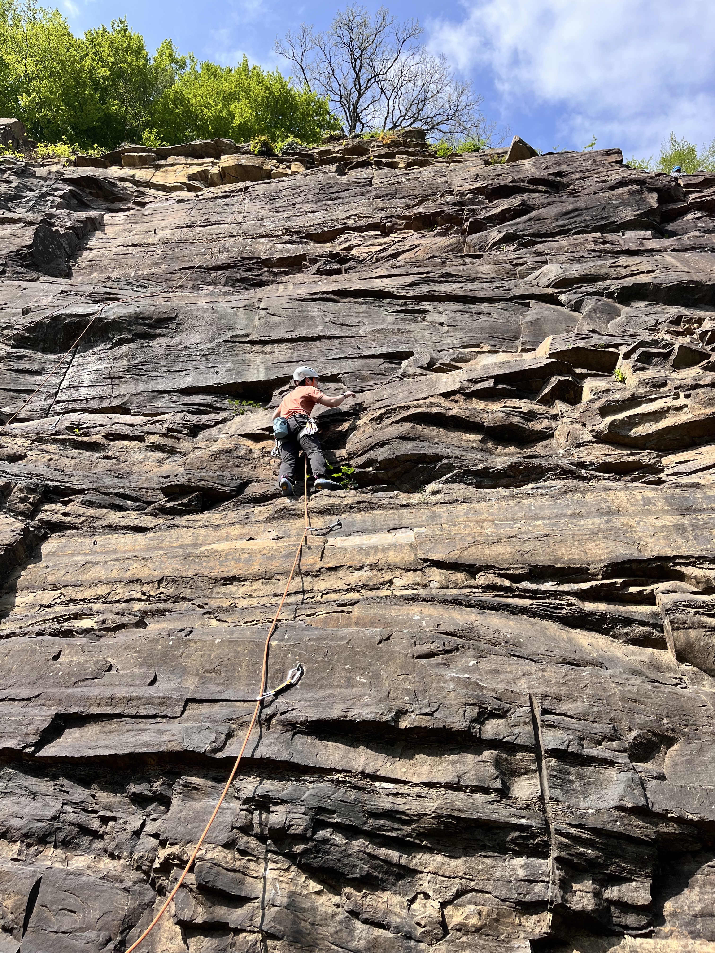 Lead climbing on layered rock face